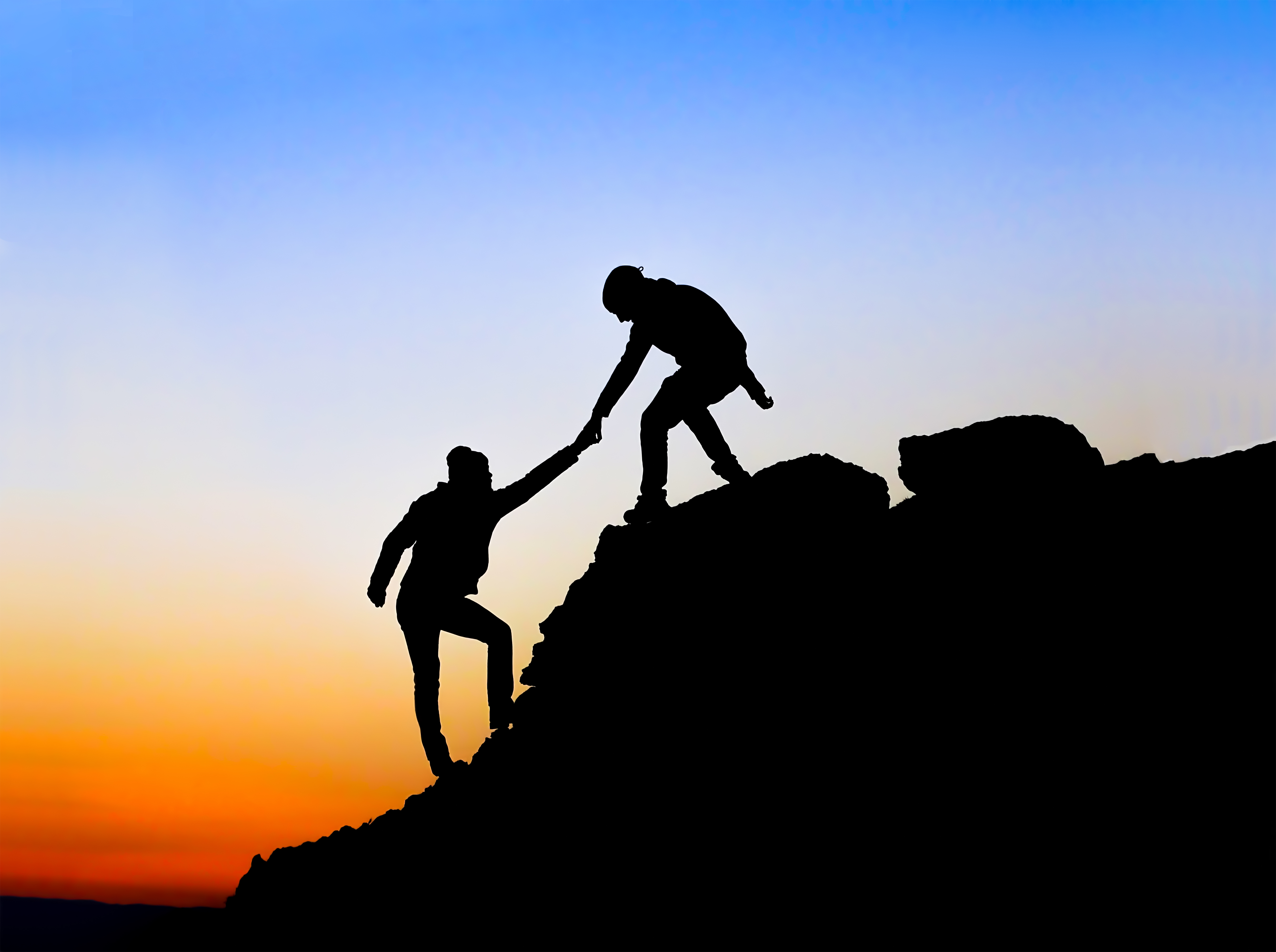 Silhouette of helping hand between two climber